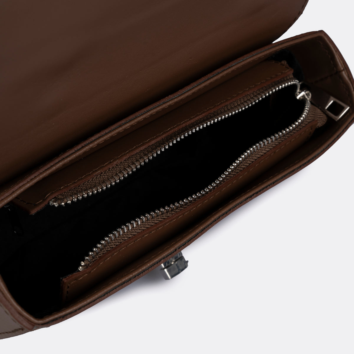 Compact cognac top-handle bag in Pelle Ruga leather with silver-tone turn-lock bar, the Capri