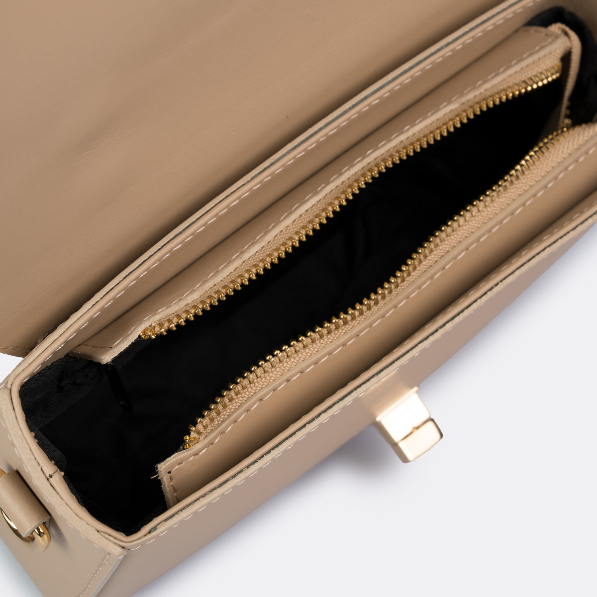 Compact taupe top-handle bag in Pelle Ruga leather with gold-tone turn-lock bar, the Capri