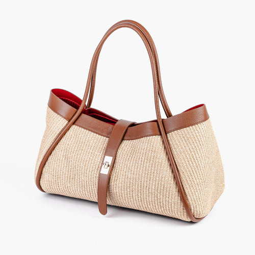 Front view of the Positano shoulder bag showing the woven raffia body and leather trim